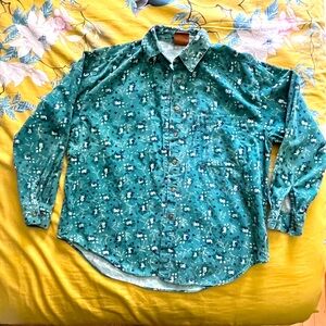 Green corduroy button down with purple and white flowers. Some wear.